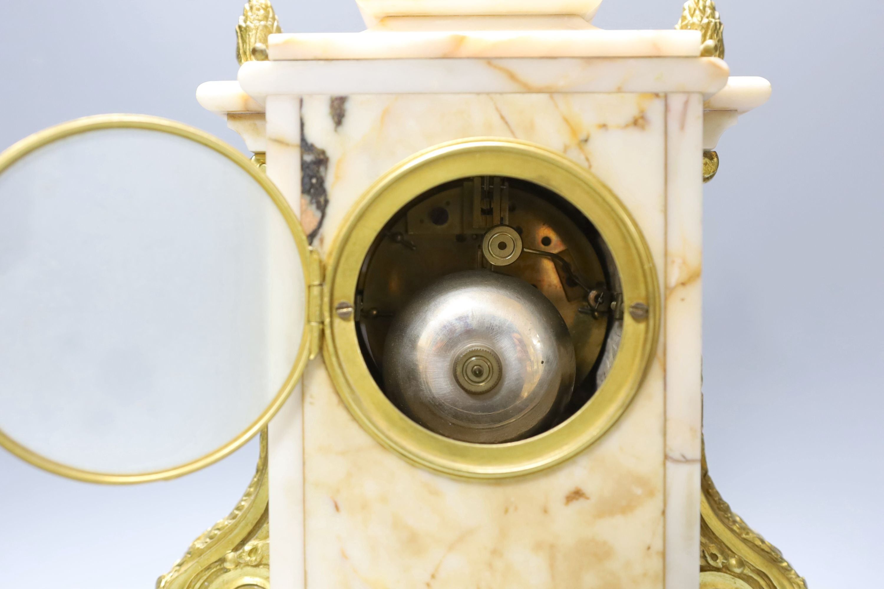 An early 20th century French gilt metal mounted marble clock with pendulum and key 35cm
